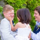 Happy gay newlywed couple with their daughter at the Santa Barbara Courthouse.