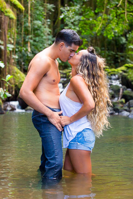 A couple kissing in a water stream in Oahu