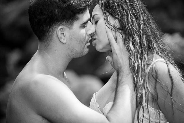 Couple passionately kissing during boudoir photoshoot