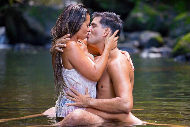 Couple passionately kissing during couples boudoir photoshoot