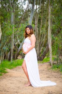 Pregnant woman posing for the camera during a photoshoot.