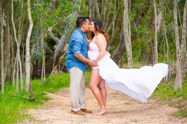 Couple kissing during a maternity photoshoot