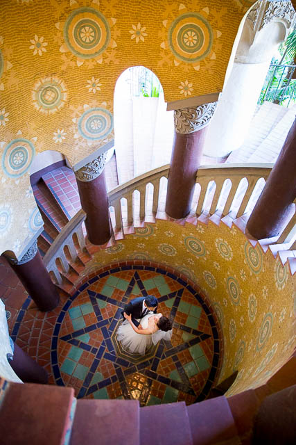 A couple located at the Santa Barbara Courthouse's iconic staircase.