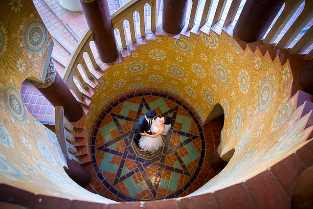 A couple located at the Santa Barbara Courthouse's iconic staircase.