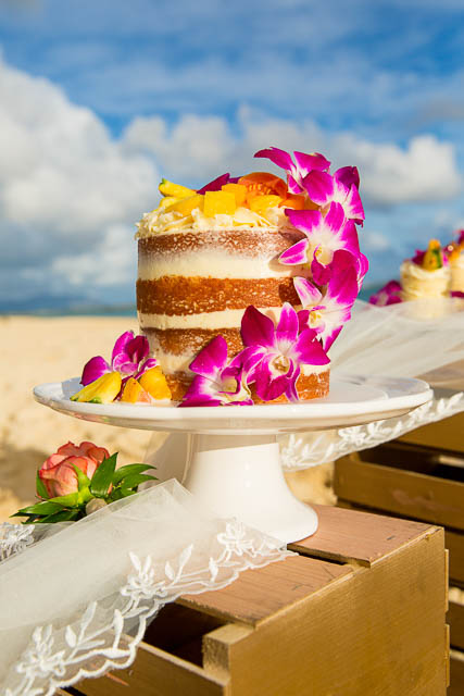 Hawaiian themed naked wedding cake on Lanikai Beach