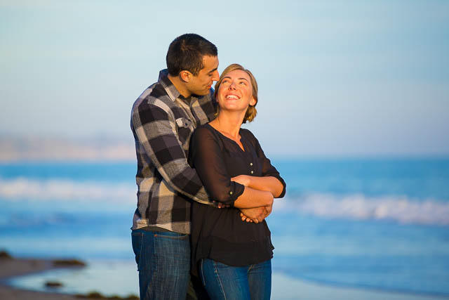 The bride and groom hold each other at Goleta Beach.