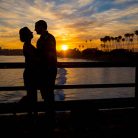 A silhouette of the bride and groom at Goleta Beach Pier.
