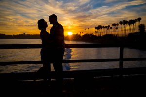 A silhouette of the bride and groom at Goleta Beach Pier.