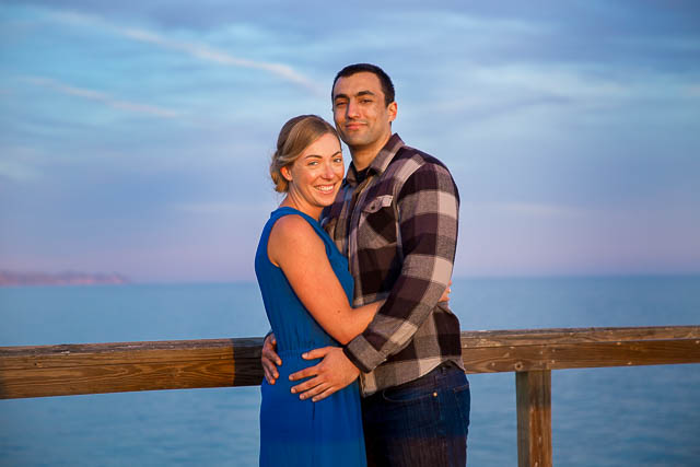 The couple posing on the pier for their Goleta engagement photos.
