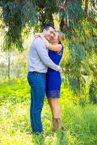 Couple hold each other along the trees at the Coronado Butterfly Preserve.