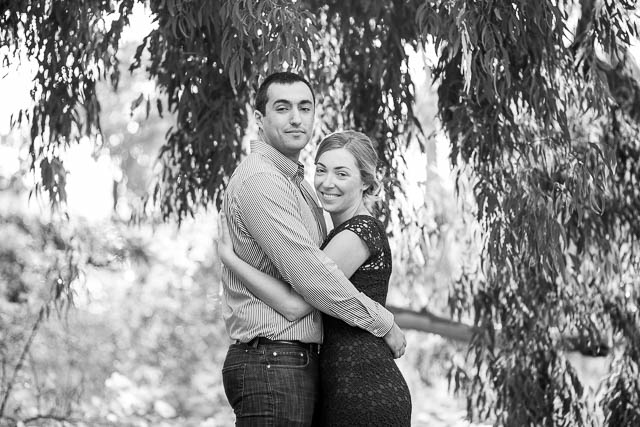 Couple hold each other along the trees at the Ellwood Butterfly Preserve.
