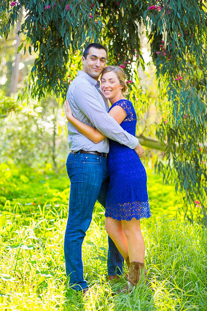 Couple hold each other along the trees at the Ellwood Butterfly Preserve.