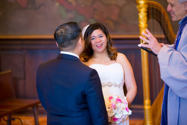 The bride and groom getting married at the Santa Barbara Courthouse Mural Room.