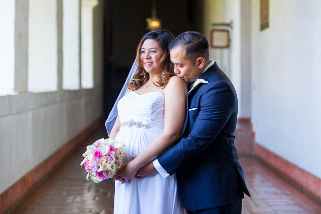 Couple holding each other after getting married at the Santa Barbara Courthouse.