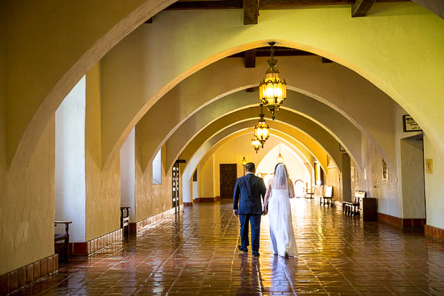 Bride and groom walking together in the Courthouse.