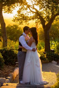 Bride and groom hugging during sunset at Elings Park wedding.