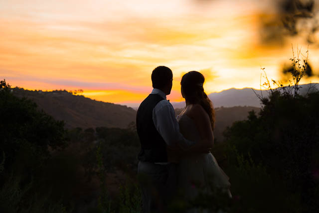 Bride and groom hugging during sunset at Elings Park wedding during Scherpa Fire..