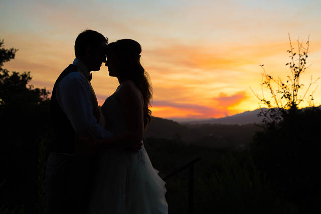 Bride and groom hugging during sunset at Elings Park wedding during Scherpa Fire..