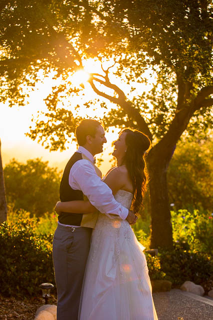 Bride and groom hugging during sunset at Elings Park wedding.