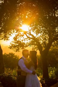 Bride and groom hugging during sunset at Elings Park wedding.