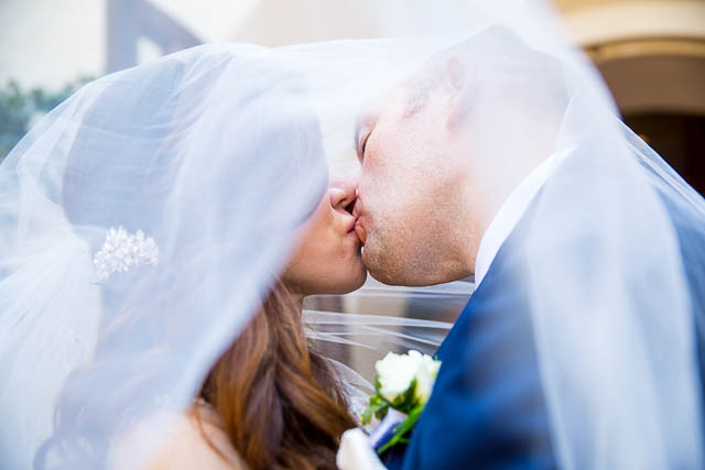 The newlyweds kissing at the Biltmore.