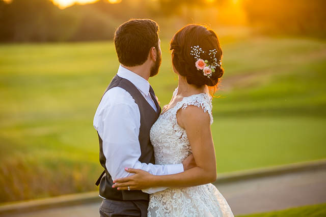 Newlyweds take sunset photos at Glen Annie Golf Club wedding.