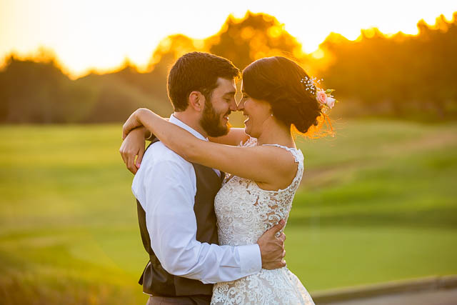 Newlyweds take sunset photos at Glen Annie Golf Club wedding.