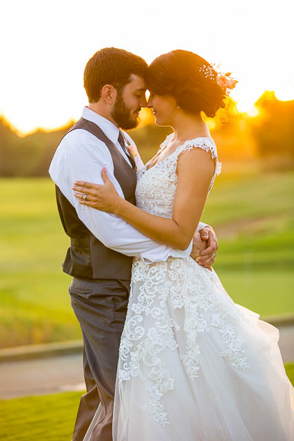 Newlyweds take sunset photos at Glen Annie Golf Club wedding.