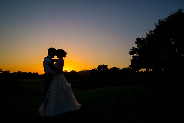 Newlyweds take silhouette sunset photos at Glen Annie Golf Club wedding.