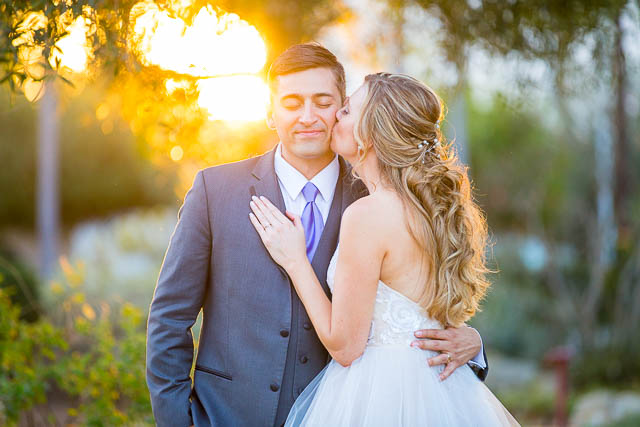 The bride and groom kissing at Alice Keck Park.