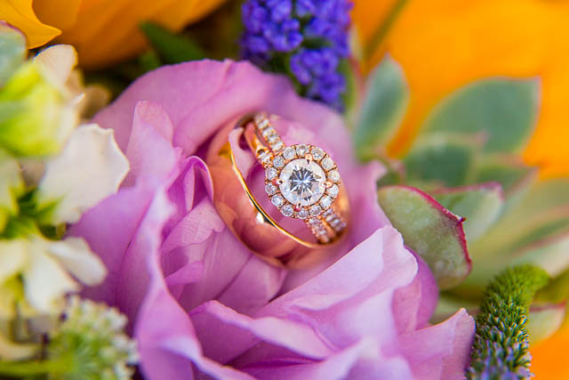 The wedding rings resting on the bride's bouquet.