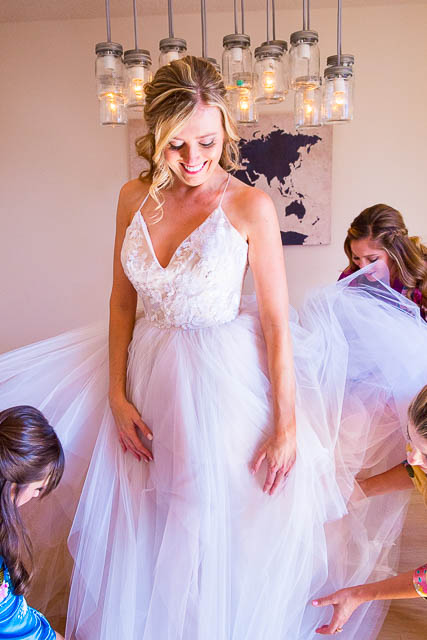 The bride getting into her Miss Hayley Paige wedding dress.