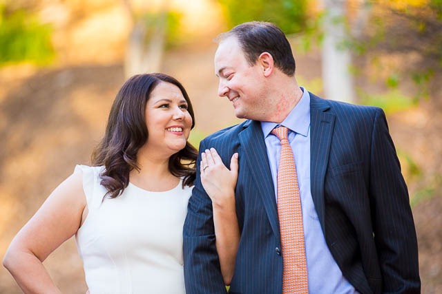 Couple standing together at the red bridge at the Langham Huntington Pasadena Hotel.