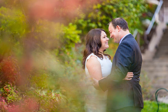 Couple kissing at the Langham Hotel Pasadena gardens.