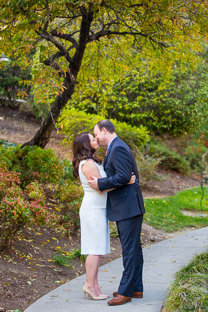 Couple kissing at the Langham Hotel Pasadena gardens.