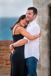 The couple holding each other during their engagement photos at the Castillo San Cristobal in Old San Juan, Puerto Rico.