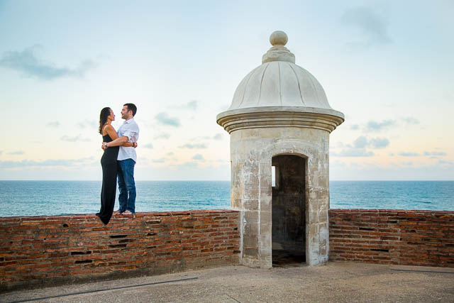 Bride and groom watching the sunset from Castillo de San Cristobal in San Juan, Puerto Rico.
