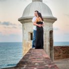 Bride and groom watching the sunset from Castillo San Cristobal in San Juan, Puerto Rico.