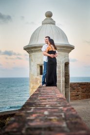 Bride and groom watching the sunset from Castillo San Cristobal in San Juan, Puerto Rico.