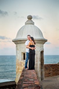 Bride and groom watching the sunset from Castillo San Cristobal in San Juan, Puerto Rico.
