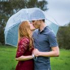 Couple kissing during their Solvang engagement photos in the rain.