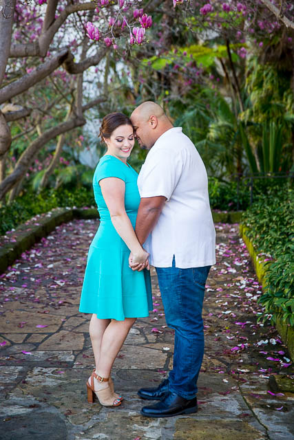 Newly engaged couple posing for their engagement photos at the Santa Barbara County Courthouse in Santa Barbara, CA.