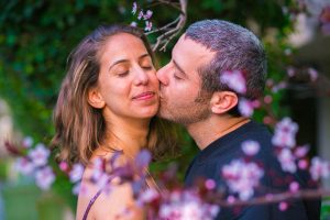 Couple kissing at the Yarkon Park in Tel Aviv, Israel.
