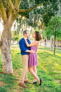 The bride holding her groom at the Yarkon Park in Tel Aviv, Israel.