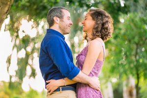 The newly engaged couple laughing together at their Tel Aviv engagement photoshoot.