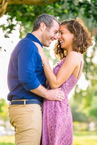 The newly engaged couple laughing together at their Tel Aviv engagement photoshoot.