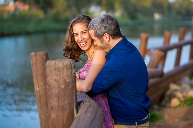 The newly engaged couple laughing together at their Tel Aviv engagement photoshoot.