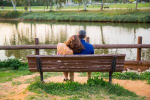 Engaged couple sitting together overlooking the Yarkon River in Tel Aviv, Isarel, during their engagement photos.