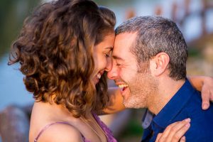 The newly engaged couple laughing together at their Tel Aviv engagement photoshoot.