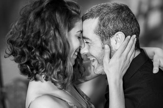 The newly engaged couple laughing together at their Tel Aviv engagement photoshoot.